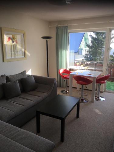 a living room with a couch and a table at Appartement an der Erlebniskappe mit Fahrradkeller in Winterberg