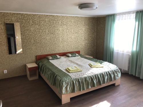 a bedroom with a bed with two towels on it at Penzion- Leslav in České Budějovice