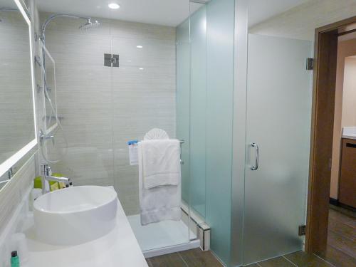 a bathroom with a shower and a sink and a toilet at Wyndham Anaheim in Anaheim