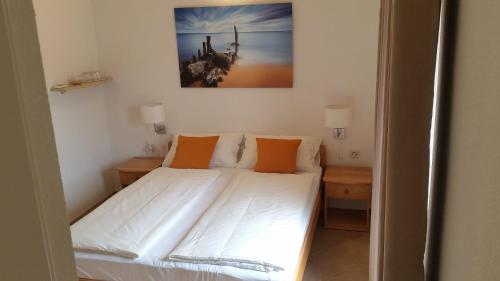 a bedroom with a bed with orange pillows at B&B La Perla in Punat