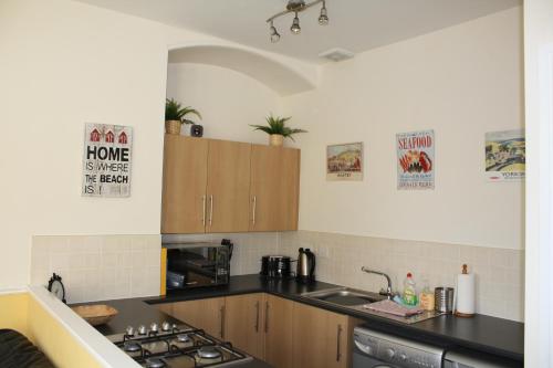 a kitchen with a sink and a stove at No3 By The Sea Apartment in Whitby