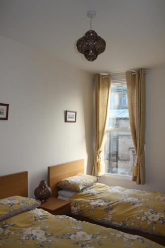 a bedroom with two beds and a window at No3 By The Sea Apartment in Whitby