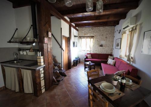 a kitchen and a living room with a red couch at Apartments Oliva in Fiorini