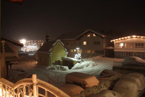 a snow covered town at night with a building at Apart Ebene in Ischgl