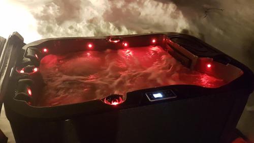 a hot tub with red lights in a room at Midt Troms Perle in Finnsnes