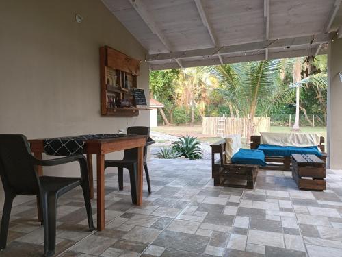 a patio with a table and chairs and a couch at B&B Le Villette Las Lajas in Las Lajas