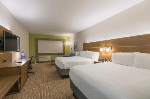 a hotel room with two beds and a flat screen tv at Holiday Inn Express & Suites - San Marcos South by IHG in San Marcos