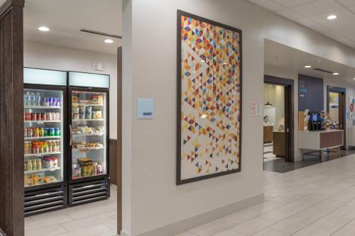 a wall with a large display of shoes in a store at Holiday Inn Express & Suites - San Marcos South by IHG in San Marcos