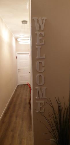 a hallway with a white door and the word exit at Glam Resort Giulia in La Spezia