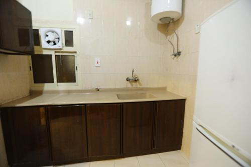 a kitchen with a sink and a counter top at Al Eairy Apartments - Al-Damam 2 in Dammam