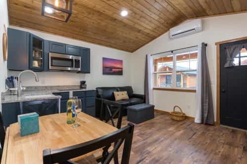 a kitchen and living room with a wooden ceiling at Woodland Inns in Forks
