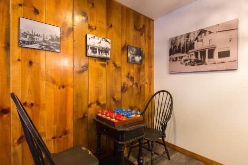 a dining room table with a painting on the wall at Woodland Inns in Forks