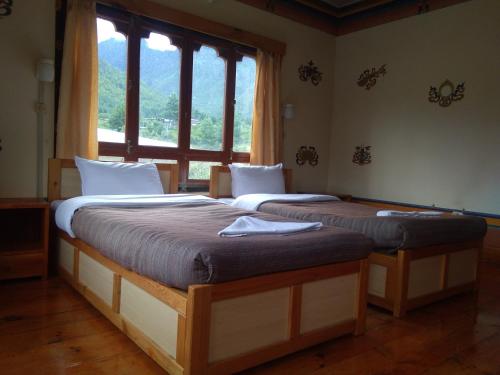 A bed or beds in a room at Nirvana Lodge