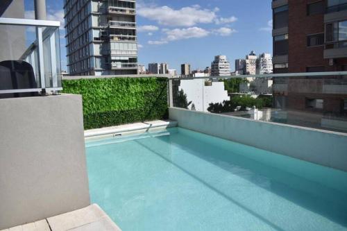 a swimming pool on the roof of a building at Trendy studio in Núñez in Buenos Aires