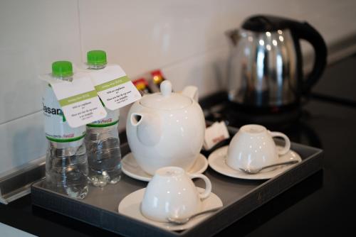 a shelf with two cups and a tea pot on it at TK VIEW HOTEL & APARTMENT in Phnom Penh