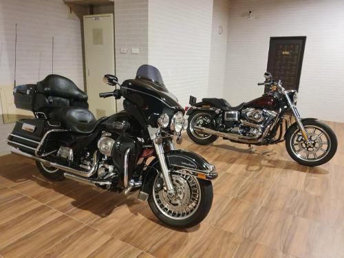 two motorcycles parked next to each other on a wooden floor at Clare Holiday B&B in Checheng
