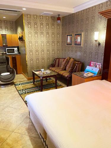 a hotel room with a bed and a living room at Hotel Venus Ritz (Adult Only) in Seto