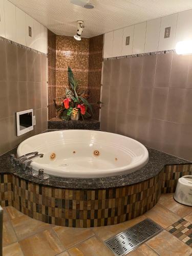 a large bath tub in a bathroom with at Hotel Venus Ritz (Adult Only) in Seto