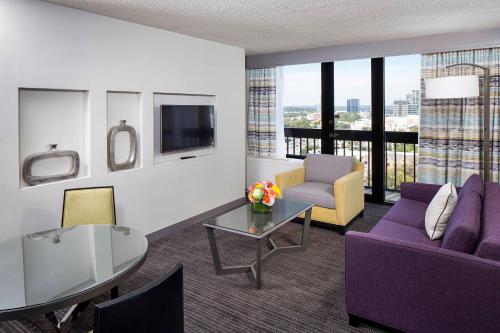 a living room with a purple couch and a table at Crowne Plaza Atlanta - Midtown by IHG in Atlanta