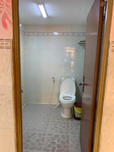 a bathroom with a white toilet in a room at Minh Tuan Hotel in Ho Chi Minh City