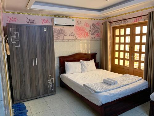 a bedroom with a bed and a large closet at Minh Tuan Hotel in Ho Chi Minh City