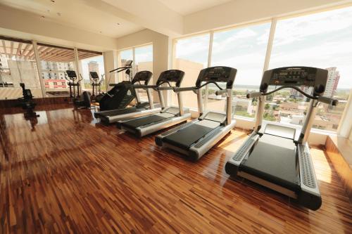 a gym with several treadmills in a room with windows at Crowne Plaza Asunción by IHG in Asuncion