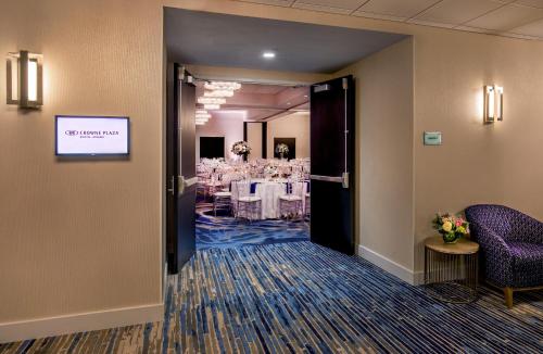 a dining room with a table in the background at Crowne Plaza Boston - Woburn by IHG in Woburn