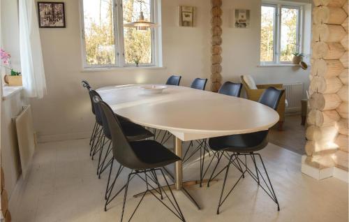 a dining room table with chairs around it at Two-Bedroom Holiday Home In Skjern in Halby