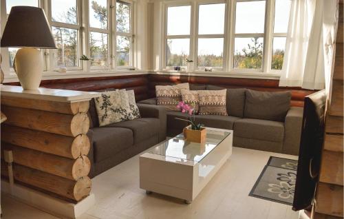 a living room with a couch and a table at Two-Bedroom Holiday Home In Skjern in Halby