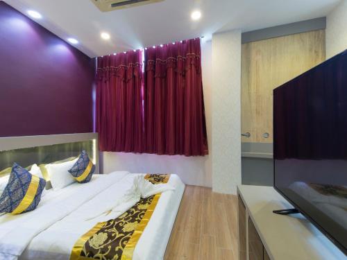 a bedroom with a bed and a red curtain at Top Garden Hotel in Hutan Melintang