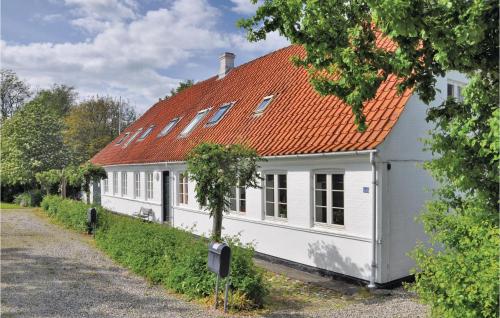 a white house with an orange roof at Three-Bedroom Holiday Home In Faaborg in Faaborg