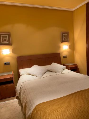 a bedroom with a large bed with two night stands at El Pino de Cerler in Cerler