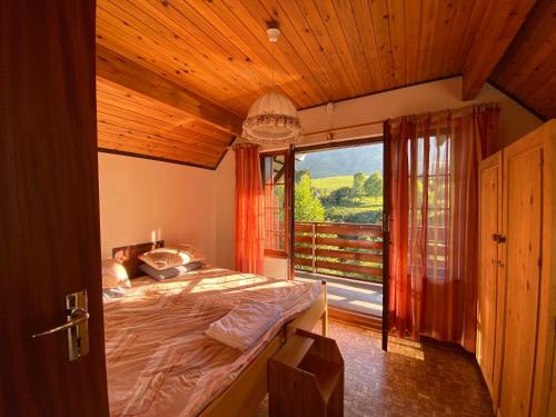 a bedroom with a bed and a large window at Drakensberg Dream, Champagne Valley in Champagne Valley