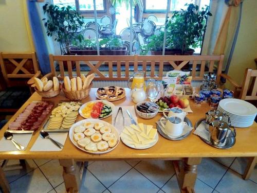 a table full of breakfast food on a table at Pension Big Apple in Železná Ruda