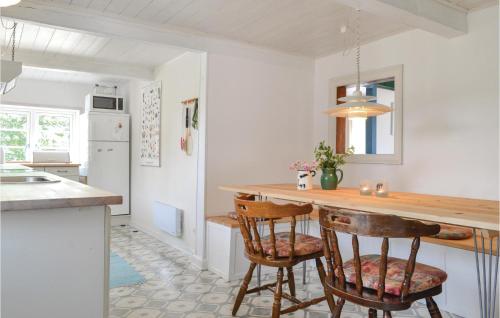a kitchen with a counter and two chairs at a table at Holiday Home Nørre Nebel 21 in Nymindegab