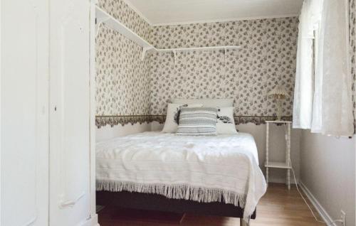 a bedroom with a bed in a room with wallpaper at 1 Bedroom Cozy Home In Torup in Torup