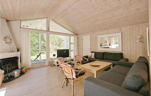a living room with a couch and a table at Hubertus in Spidsegård