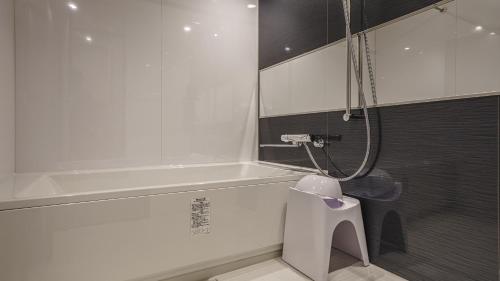 a bathroom with a bath tub and a toilet at Hotel Aoka Kamigoto in Shinkamigoto