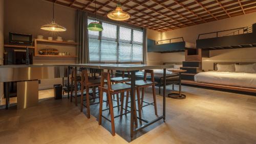a kitchen with a bar and a bedroom with a bed at Hotel Aoka Kamigoto in Shinkamigoto