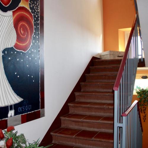 a staircase in a house with a painting on the wall at CAMINATA 415 in Fiorenzuola dʼArda