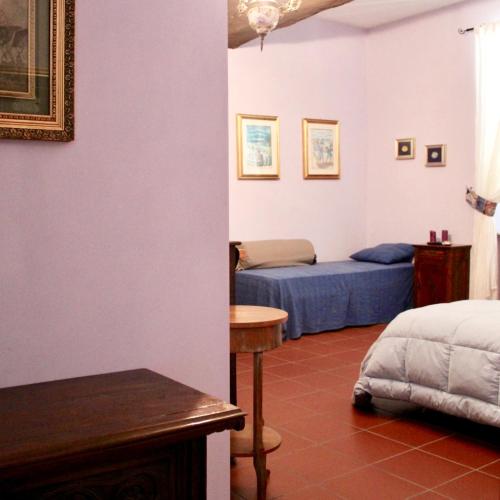 a bedroom with a bed and a table in a room at CAMINATA 415 in Fiorenzuola dʼArda