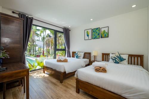Кровать или кровати в номере Melica Resort Phu Quoc