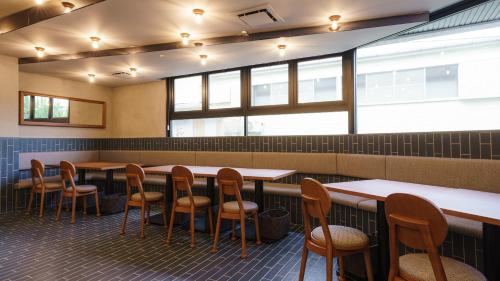 a row of tables and chairs in a restaurant at Hotel Aoka Kamigoto in Shinkamigoto