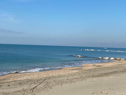 a beach with some rocks in the water at Residence La Duna in Castel Volturno