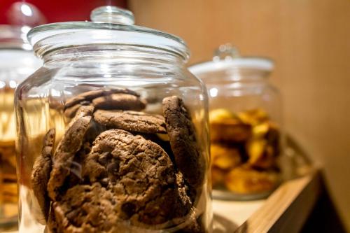 a glass jar filled with cookies and other food at Ostal Pau Universite - Sure Hotel Collection by Best Western in Pau