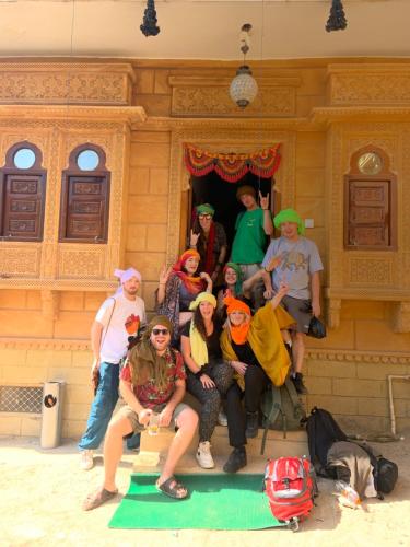 a group of people posing for a picture in a building at Blue Eye Hostel in Jaisalmer
