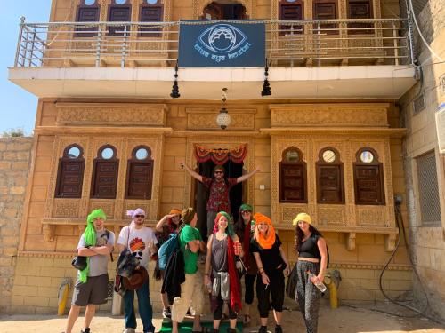 a group of people standing in front of a building at Blue Eye Hostel in Jaisalmer