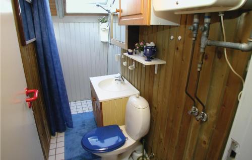 a small bathroom with a toilet and a sink at 2 Bedroom Lovely Home In Rm in Bolilmark