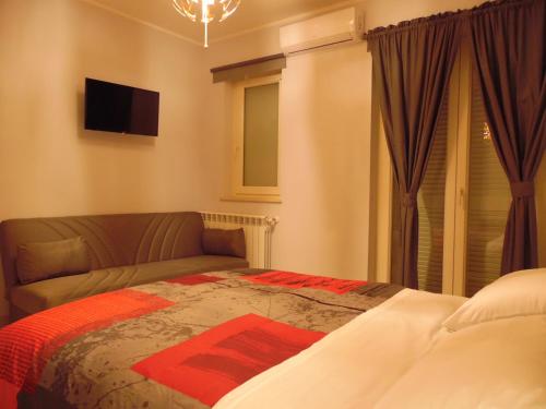 a bedroom with a bed and a couch at B&B White One in San Prisco