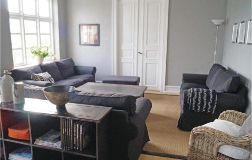 a living room with a couch and a table at Holiday Home Stoense Udflyttervej in Skattebølle